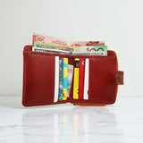 Woman’s Genuine Leather Button Tab Zip Around Wallet - Tan